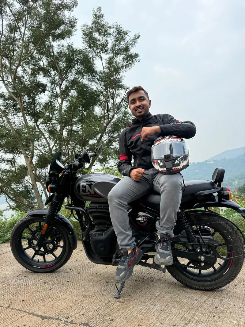 Omkar on his motorcycle in the hills
